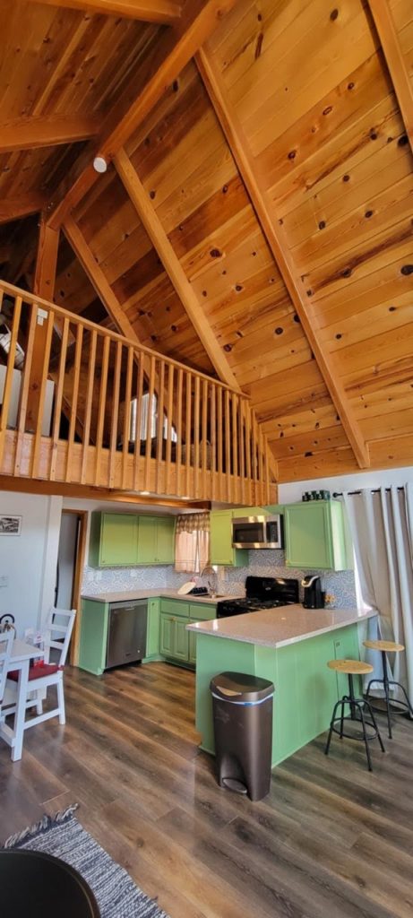 Rustic wooden ceiling and cozy kitchen design at Producers Construction modern home renovation. Expert craftsmanship in interior woodwork, cabinetry, and open-concept living spaces for stylish, functional homes.
